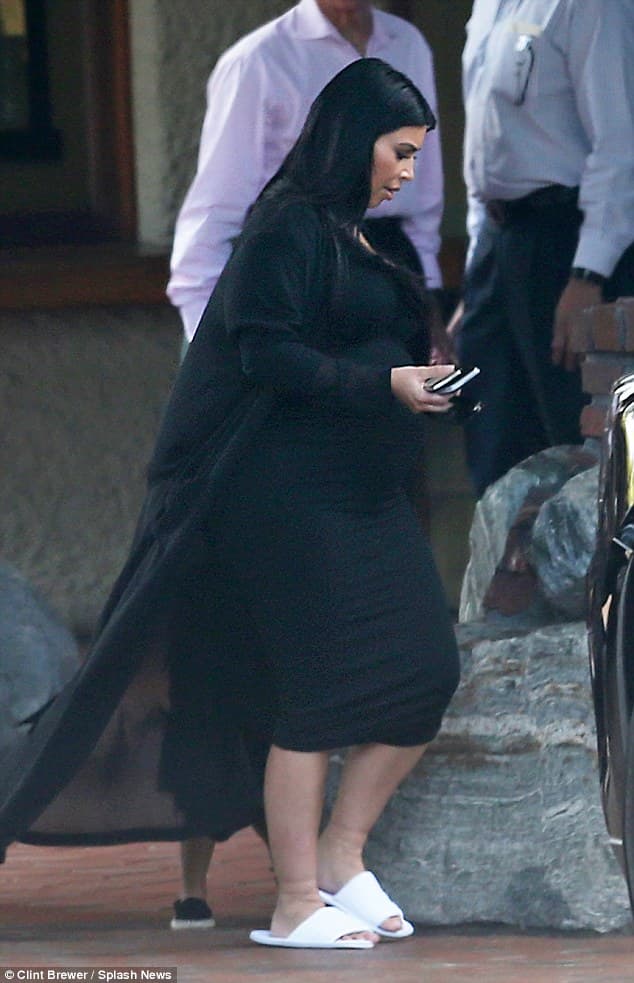 Kim Kardashian shuffles out of hotel in comfy slippers
